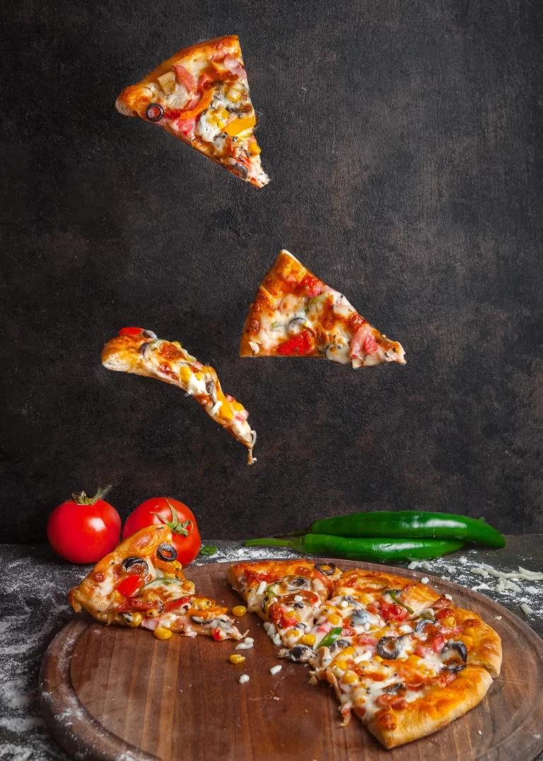 side-view-pizza-with-pepper-tomato-pizza-slices-board-cookware